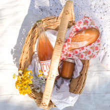 Load image into Gallery viewer, red floral beeswax wrap in picnic basket with orange wine and honey
